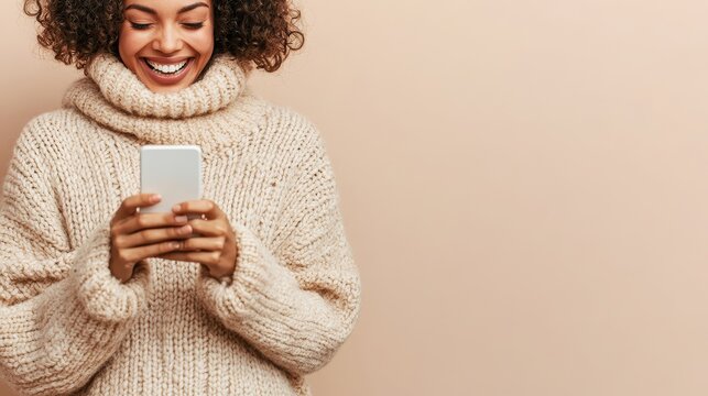 Joyful woman with curly hair smiling at engaging digital content on mobile device. Happy person demonstrating social media marketing, viral campaign.
