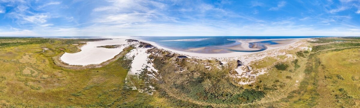 Aerial view of remote nature reserve with dunes, valleys, thickets and sandbars along North Sea beach, in 360 degrees panorama, Noordsvaarder, Wadden island Terschelling, Friesland, Netherlands.