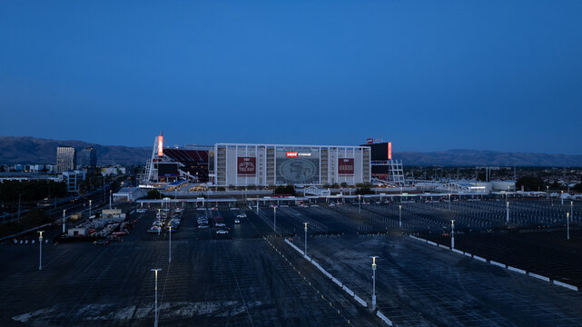 Santa Clara, United States - 02 September 2025: Aerial view of Levi's Stadium under the fading blue of twilight, a modern coliseum amidst orderly parking lots.