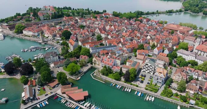 Aerial view of Lindau island, a tapestry of red-roofed buildings nestled against the azure waters of Lake Constance, Bodenseeinsel Lindau, Germany.