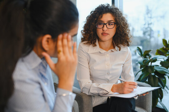 Psychologist counseling indian woman during therapy session