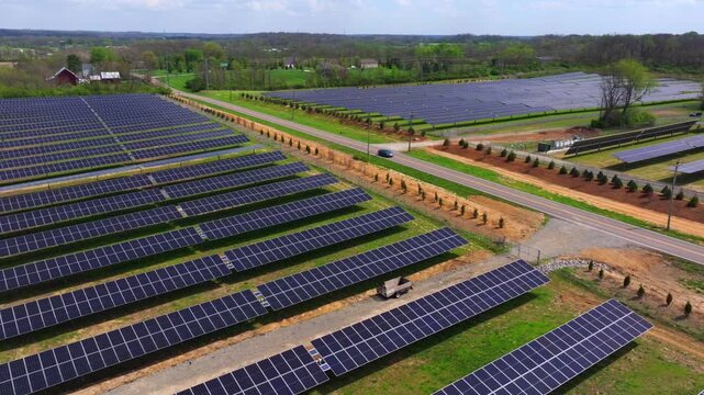 Aerial view of rows of solar panels contrast against the green field, capturing the essence of renewable energy, Lebanon, Ohio, United States.