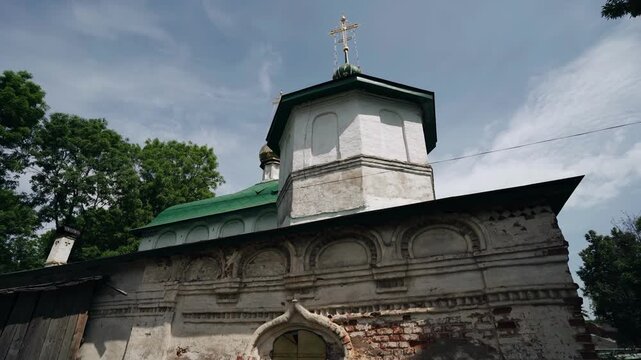 The wall of an old Christian church. Slightly crumbled bricks and a scuffed wall