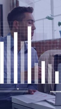 Seated business pro adjusting pages and reaching laptop, grid and bar chart over hands showing data