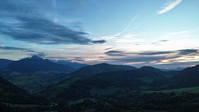 Aerial hyperlapse of dramatic sunset over mountain ridges