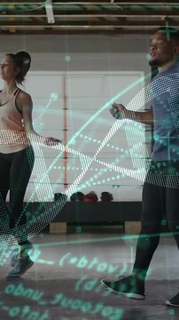 Vertical video: Man and woman training jumping rope on start in gym, DNA helix and code over pair