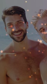 Vertical video: Bearded man smiling, friends joining and leaning, stars dotting faces, forming ad