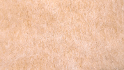 Macro texture of soft fluffy peach-colored wool fleece © irenka