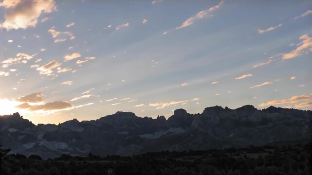 Dark mountain silhouettes at last sunlight