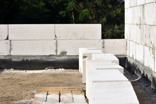 Unfinished walls made of white aerated concrete blocks. Construction site of a utility room under construction. Engineering technology, construction. Foam concrete block. work is underway block laying