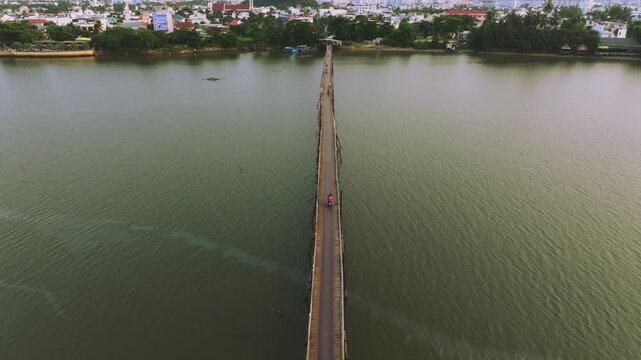 Aerial 4K of traditional Phu Kien wooden bridge crossing Cai River, Nha Trang, Vietnam
the authentic charm of rural Vietnam, highlighting the traditional engineering, peaceful tropical landscape