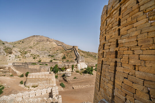 Desert landscape view of Sann gate ramparts and sandstone bastion at ancient Ranikot fort aka the Great Wall of Sindh, Jamshoro, Sindh, Pakistan
