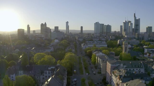 A smooth forward-moving drone shot showcasing the iconic skyline of Frankfurt am Main, Germany. The Europaturm stands prominently in the center, surrounded by famous skyscrapers like the Messeturm and