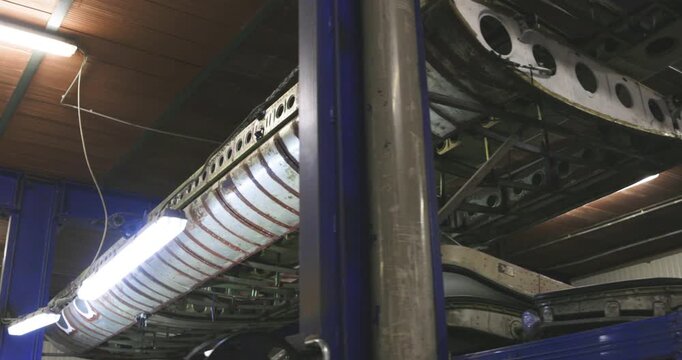 Low angle shot of large industrial metal components and structures inside a factory or hangar
