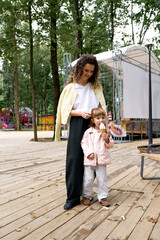 Fototapeta premium Enjoying ice cream together in a lively amusement park under sunny skies