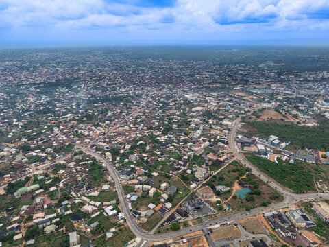Aerial view of the sprawling urban landscape where buildings nestle among lush greenery under a vast sky, Ihie Ndume, Umuahia, Abia, Nigeria.