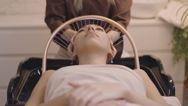 Woman receiving a relaxing head spa scalp massage