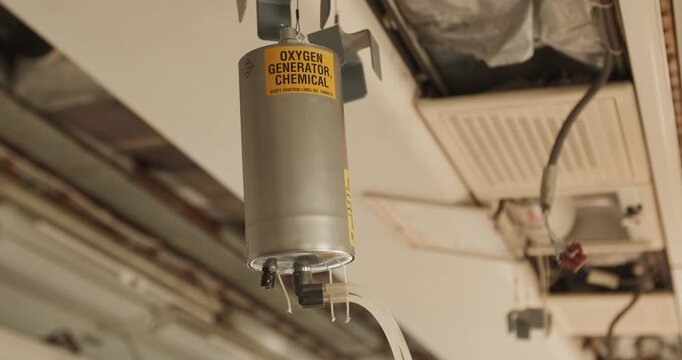 Close-up of a chemical oxygen generator unit mounted in an aircraft service panel