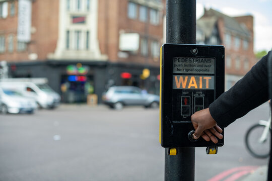 Pedestrian crossing button on street.