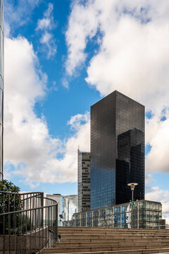 Skyscraper tower skyline under clouds with steps to a terrace in urban finance hub La Defense expressing modernity in Paris France today