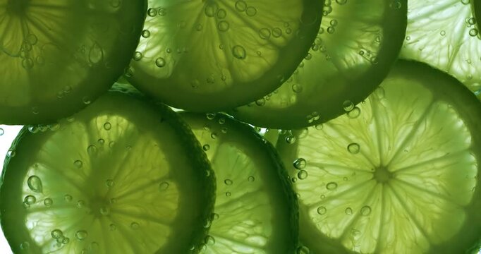 Lime Slices falling deeply under water. Shot on super slow motion camera 1000 fps.