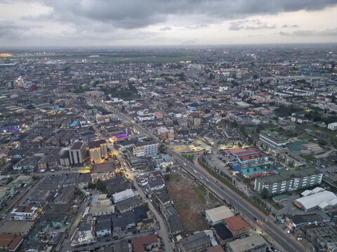 Aerial view of the Allen Avenue's bustling streets and buildings under a vast, cloudy sky, Ikeja, Lagos, Nigeria.