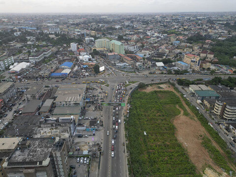 Aerial view of a bustling Allen Avenue, where traffic weaves through the heart of Ikeja amidst a vibrant mix of buildings and open spaces, Ikeja, Lagos, Nigeria.