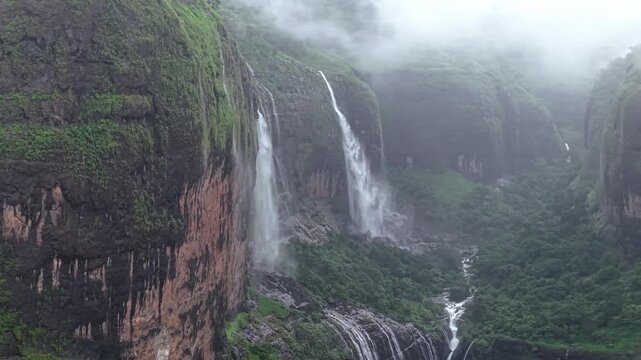Moving Drone shot of a Huge explosive waterfall shot during heavy monsoon. Three tier waterfall. Tallest waterfall in India. Drone clip 4K60