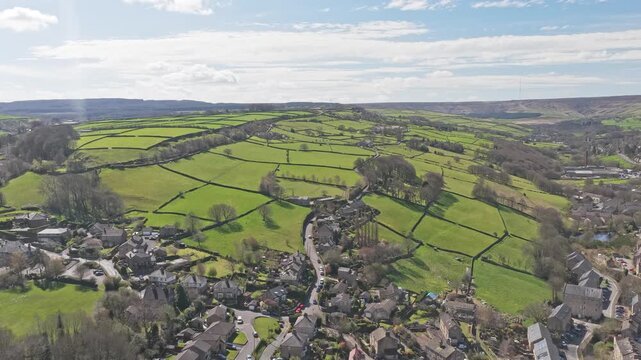 Holme Valley near Holmfirth Kirklees West Yorkshire England with rural village edge, winding lane and enclosed pasture fields with dry stone walls on Pennine hills, drone slow glide shot
