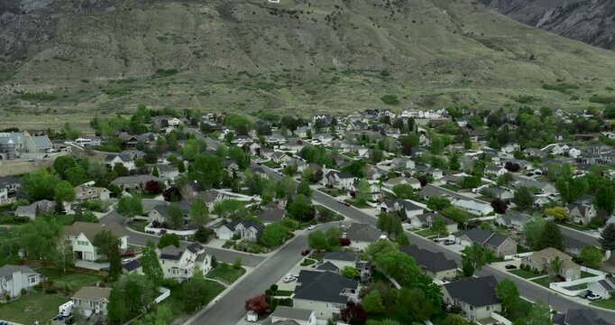 Pleasant Grove in Utah USA within Utah Valley with curvilinear subdivision streets on alluvial bench at base of Wasatch Range marking transition from grid valley development to foothill housing aerial