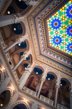 Sarajevo, Bosnia and Herzegovina - 07 May 2025: View of the Gazi Husrev-beg Library's ceiling, a symphony of blues, golds, and vibrant stained glass forming intricate patterns above.