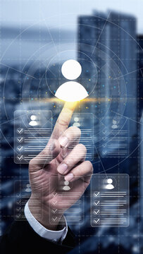 Businessman hand touching virtual profile icons on a digital interface, representing recruitment, human resources management, and talent acquisition in a modern city