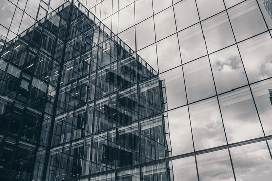 Modern corporate facade in glass reflection and grid architecture with monochrome pattern and symmetry for a minimalist business backdrop