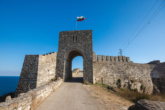 Kaliakra fortress gate on Cape Kaliakra with Bulgarian flag above Black Sea coast