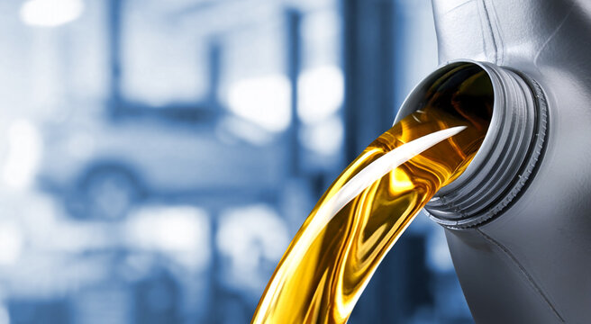 Pouring motor oil into the car engine