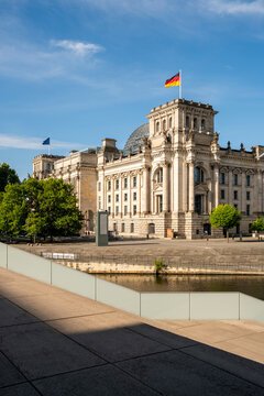 Berlin Reichstag Bundestag flag over parliament government building landmark in Germany captured in bright daylight with clean urban perspective