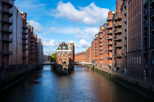 Iconic Wasserschloss brick warehouse at a canal waterfront in Hamburg Speicherstadt with reflection and architecture as a Germany landmark in daylight