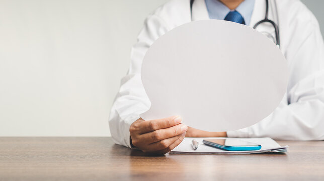 Doctor holding blank speech bubble for medical message