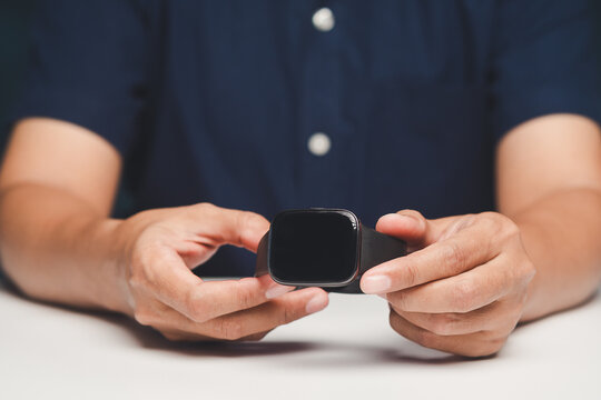 Person holding smartwatch device in hands close up