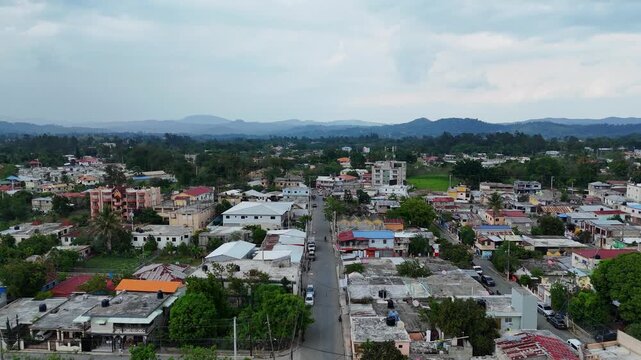 Aerial drone view of homes and buildings in Jarabacoa town on cloudy day, Dominican Republic