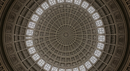 Obraz premium Intricate domed ceiling with detailed geometric patterns and window openings.