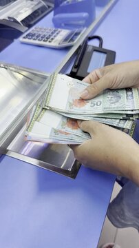 Hands holding Malaysian ringgit banknotes close up Malaysia &mdash; person counting local currency bills in natural light, perfect for finance, travel money, currency exchange, economy, banking, budget trav