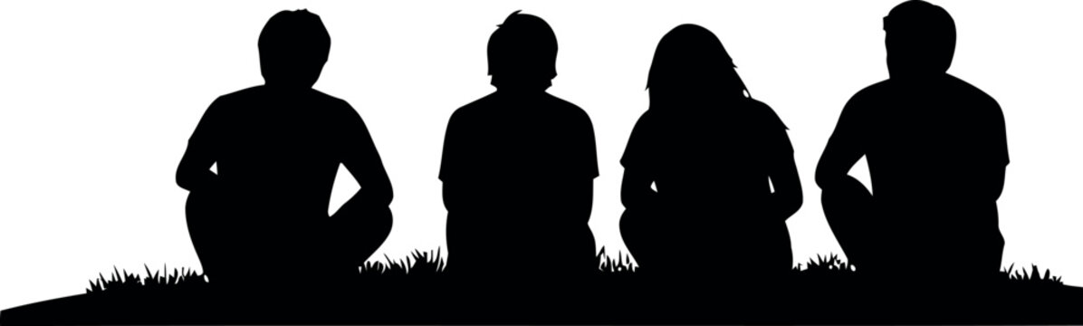 Silhouetted group of four individuals standing together against a bright undefined background