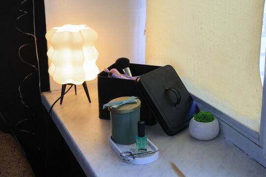 Cozy vanity corner with a decorative lamp and makeup essentials organized neatly