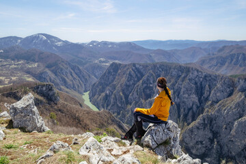 Fototapeta premium Girl in the mountains. Tara National Park, Serbia