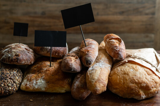 Assorted rustic breads with labels.