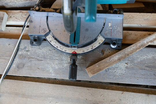 Angle Gauge On Miter Saw With Sawdust On Wooden Workbench During Carpentry Project