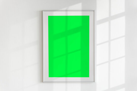 Minimalistic blank framed poster with shadows, suitable as mockup