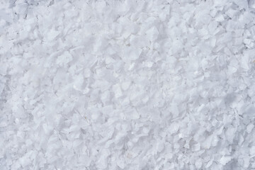 White sea salt flakes creating abstract texture background