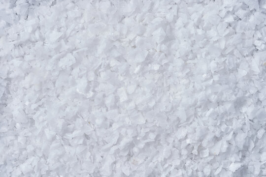 White sea salt flakes creating abstract texture background